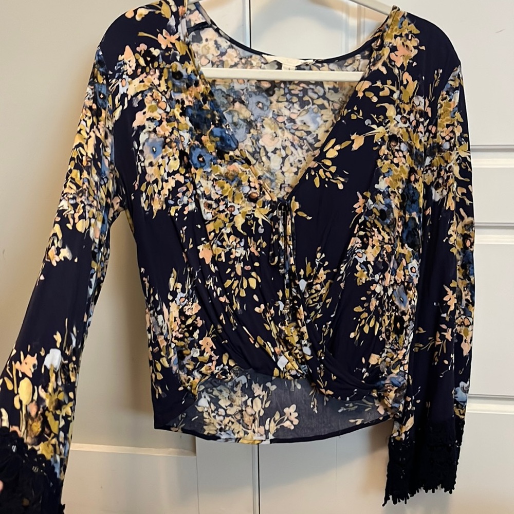 Blue blouse with mustard colored accents. Belle sleeve and knit detail.